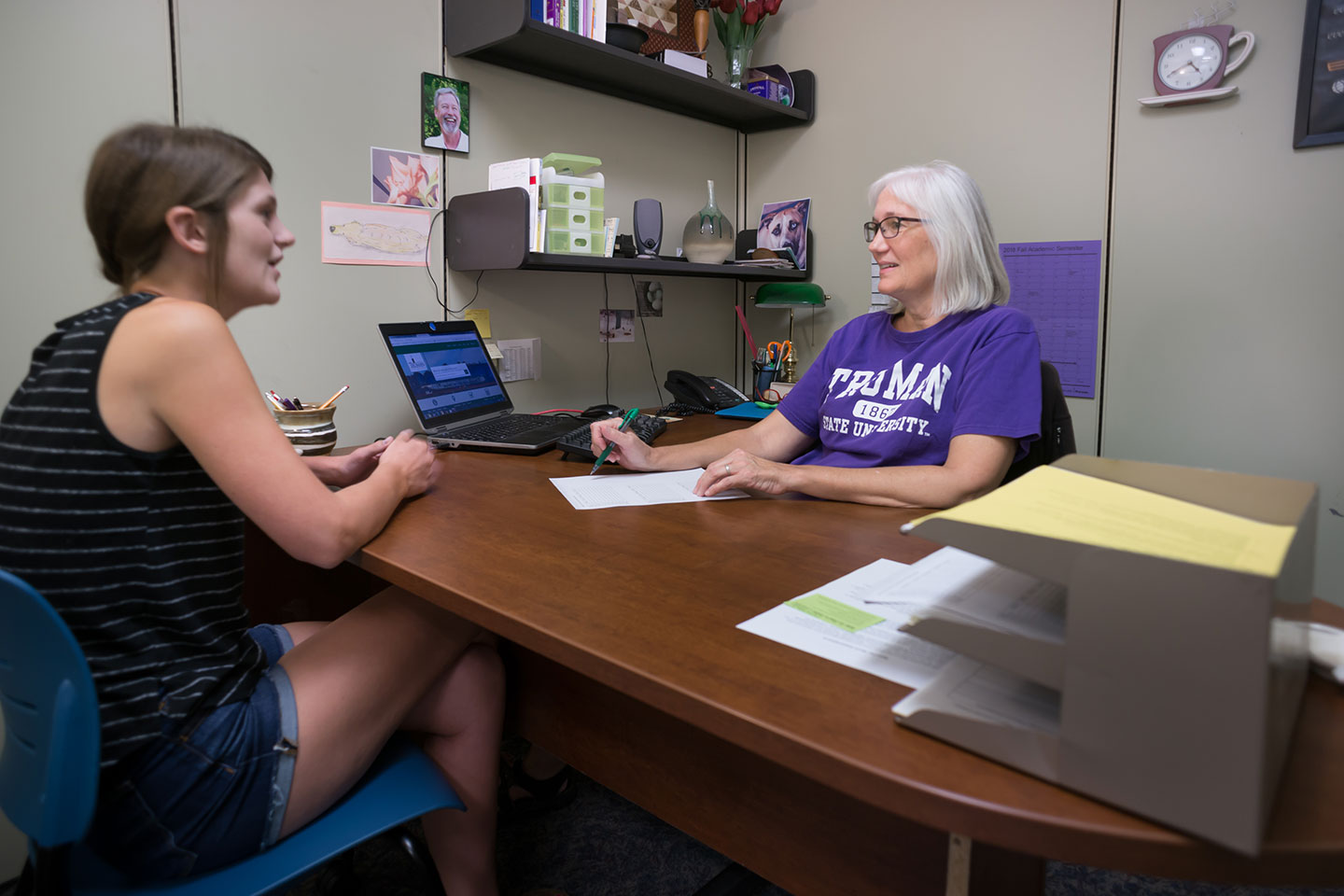 Student talking with an academic advisor